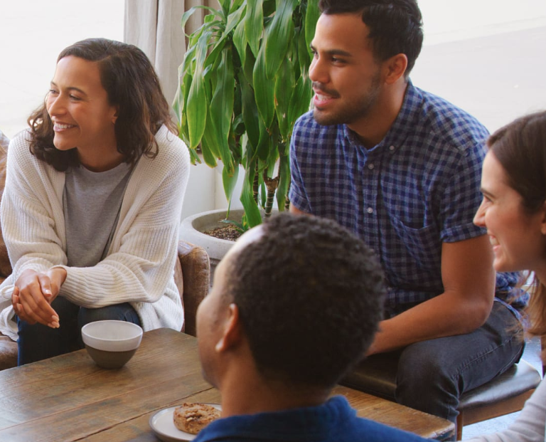 A team having a coffee sitting and working together at a coffee table