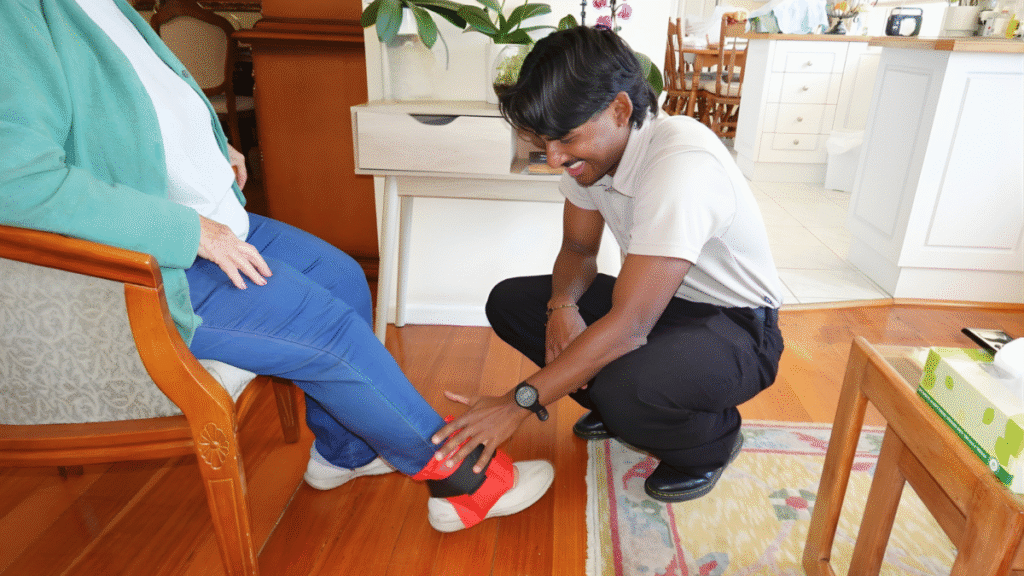 Mobile Physiotherapist doing a knee exercise with a patient at home in Melbourne