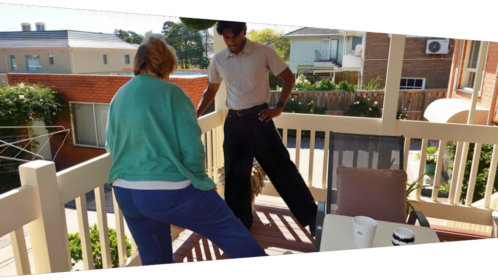 Mobile Physiotherapist in Melbourne doing standing hip abduction exercise with patient at their home