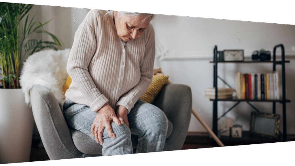 Elderly at home holding onto her knee due to pain