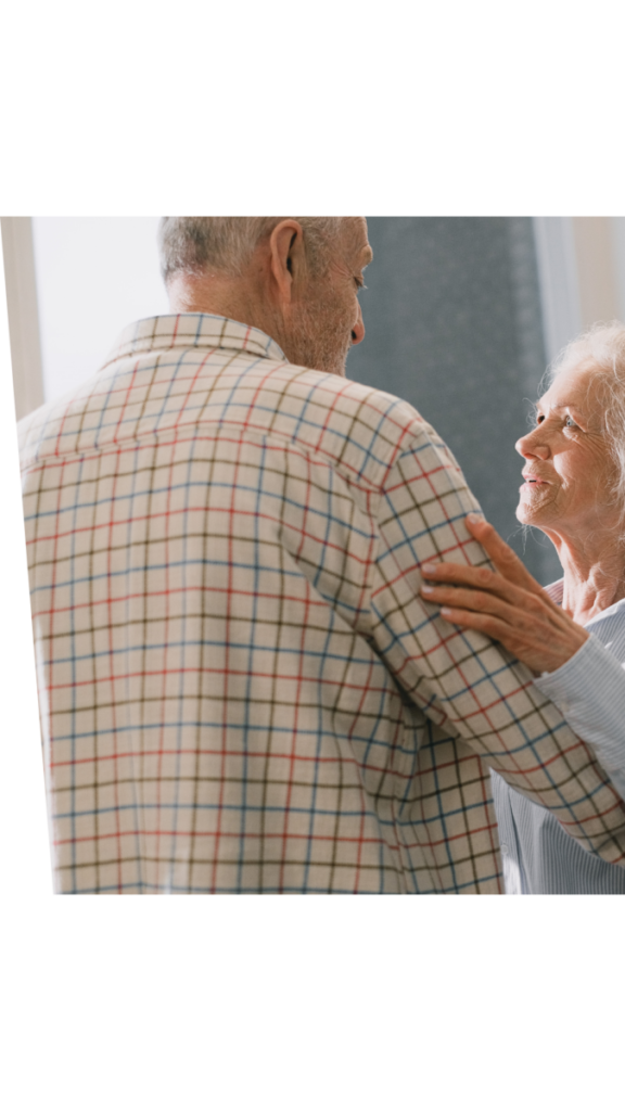Happy elderly couple holding each other in the living room